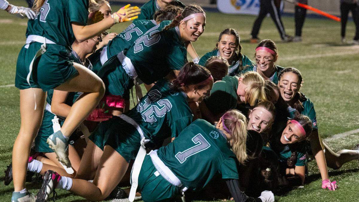 The Ponderosa Bruins dogpile on the field to celebrate winning the Sac-Joaquin Section Division II championship girls flag football game on Saturday, Nov. 9, 2024, at Cosumnes River College. The school finished undefeated in its first season in the sport.