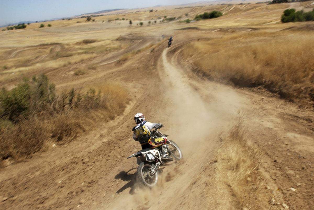 A biker rides the dirt trails at Prairie City State Vehicular Recreation Area.