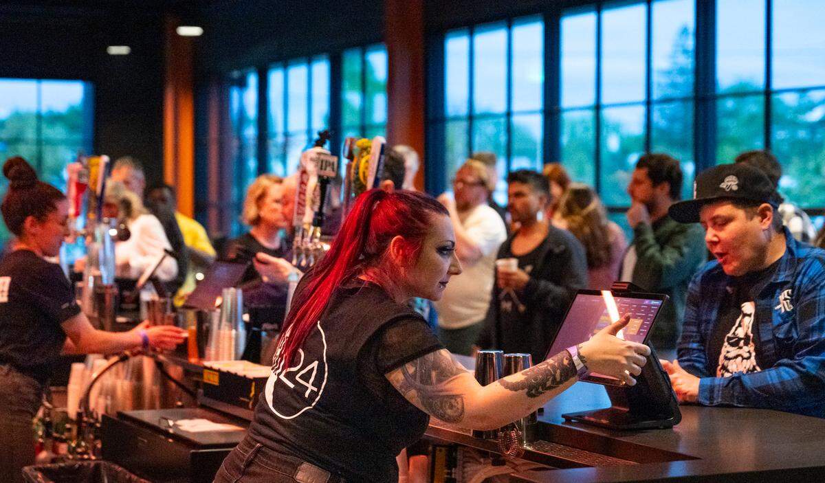 Bartenders serve patrons on the second floor during the opening weekend for Channel 24, a new concert venue in midtown.