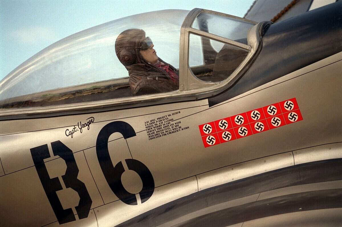 A replica of Gen. Chuck Yeager’s P-51 Mustang WWII-era fighter plane, marked with Nazi flags indicating the number of planes shot down by Yeager, waits in 1999 to be lifted by crane atop a 46-foot-tall reproduction of an airport control tower built above Aces Supper Club.