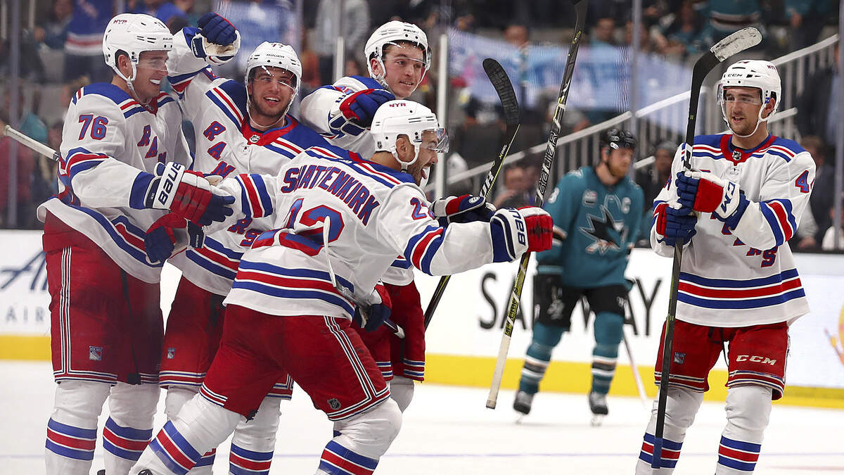 New York Rangers’ Kevin Shattenkirk, center, is congratulated after scoring the game-winning shootout goal against the Sharks on Tuesday in San Jose.