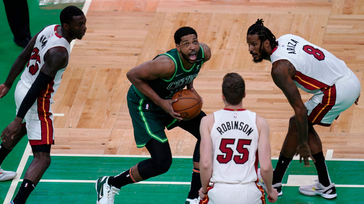 Boston Celtics center Tristan Thompson is surrounded by Miami Heat players during the first half of an NBA basketball game, Tuesday, May 11, 2021, in Boston. (AP Photo/Charles Krupa)