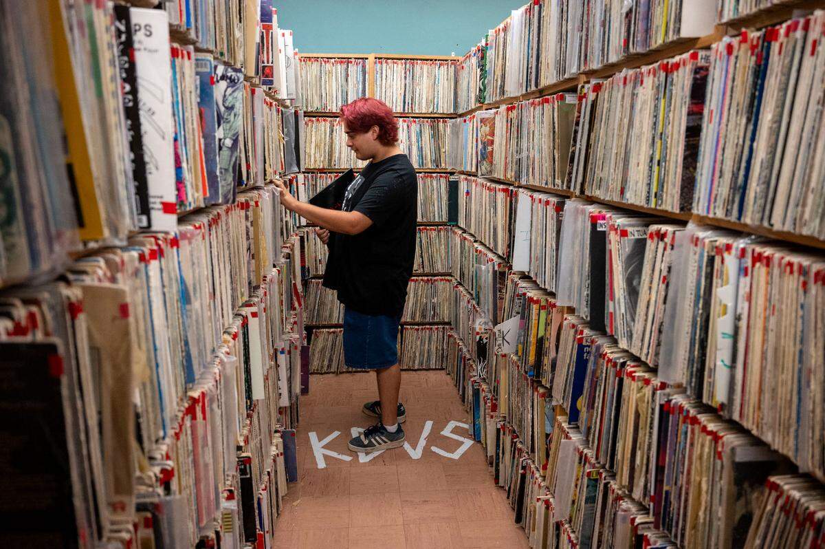 Izzy Barney, one of the event coordinators at KDVS radio station at UC Davis, looks through their vinyl record collection last month. The station is being evicted from the basement of Freeborn Hall where its been broadcasting for 60 years and has collected roughly 150,000 CDs, vinyl records and cassette tapes.