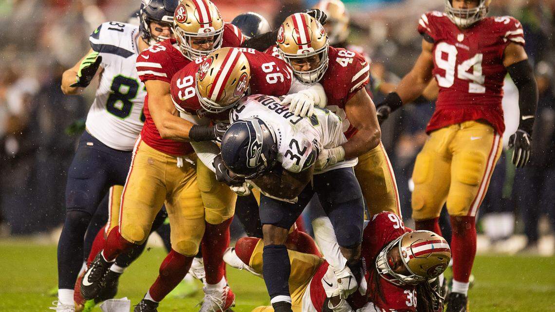 Seahawks running back Chris Carson (32) is tackled by 49ers defensive tackle DeForest Buckner (99), linebacker Fred Warner (48), defensive back Marcell Harris (36) and outside linebacker Mark Nzeocha (53) in the fourth quarter at Levi’s Stadium on Sunday, Dec. 16, 2018, in Santa Clara. The Seahawks averaged just 5.6 yards per play in their 26-23 overtime loss to the 49ers.