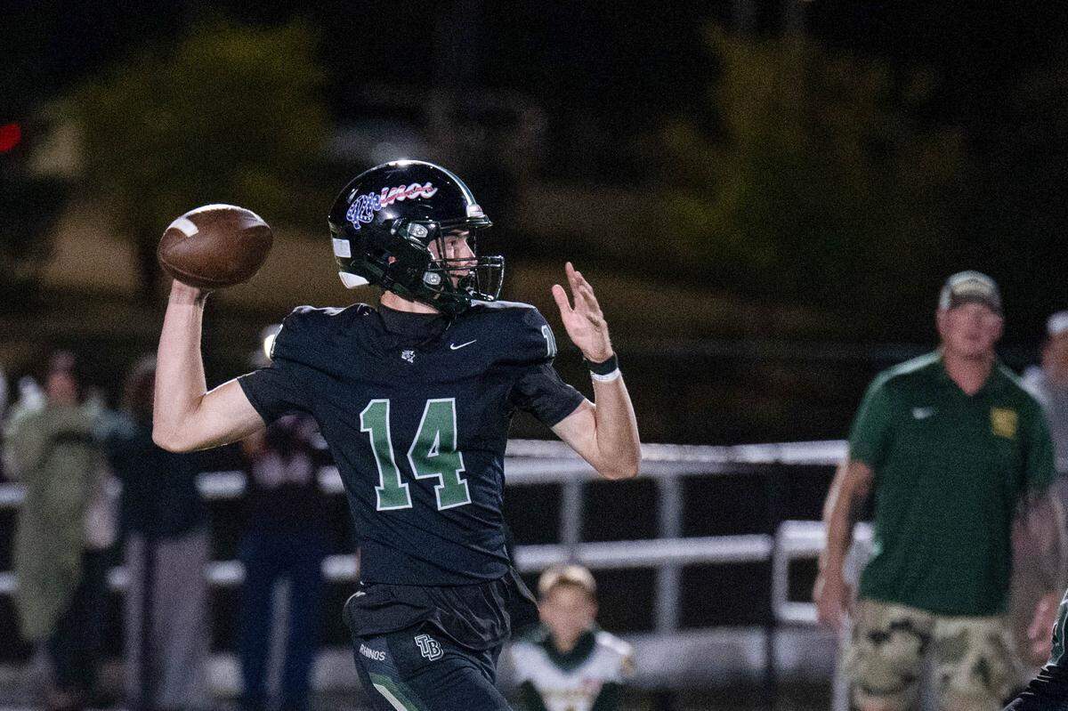 The Twelve Bridges Raging Rhinos' Connor Frontiera (14) throws a pass in the first half against the Placer Hillmen on Friday in Lincoln.