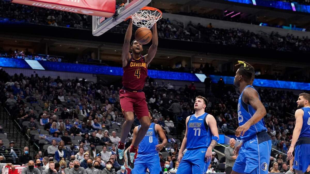 Cleveland Cavaliers center Evan Mobley (4) dunks as Dallas Mavericks’ Sterling Brown (0), Luka Doncic (77), Reggie Bullock, second from right, and Maxi Kleber, right, look on in the second half of an NBA basketball game in Dallas, Monday, Nov. 29, 2021. (AP Photo/Tony Gutierrez)