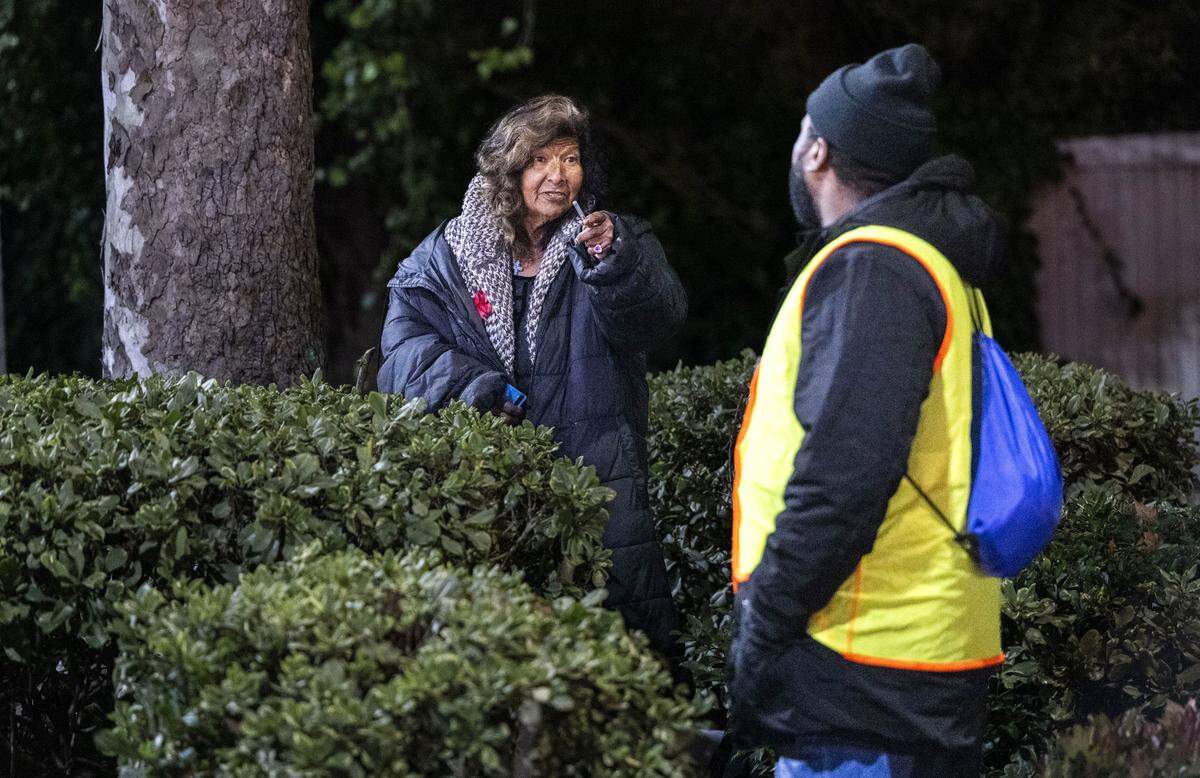 Sandra Montez, who said she has been living on the streets for 25 years, directs Khalil Owens, with the nonprofit Community HealthWorks, to other homeless residents living nearby during the Sacramento County Point-in-Time Count on Monday. The survey is conducted every two years to measure the number and demographics of the county's homeless population. 