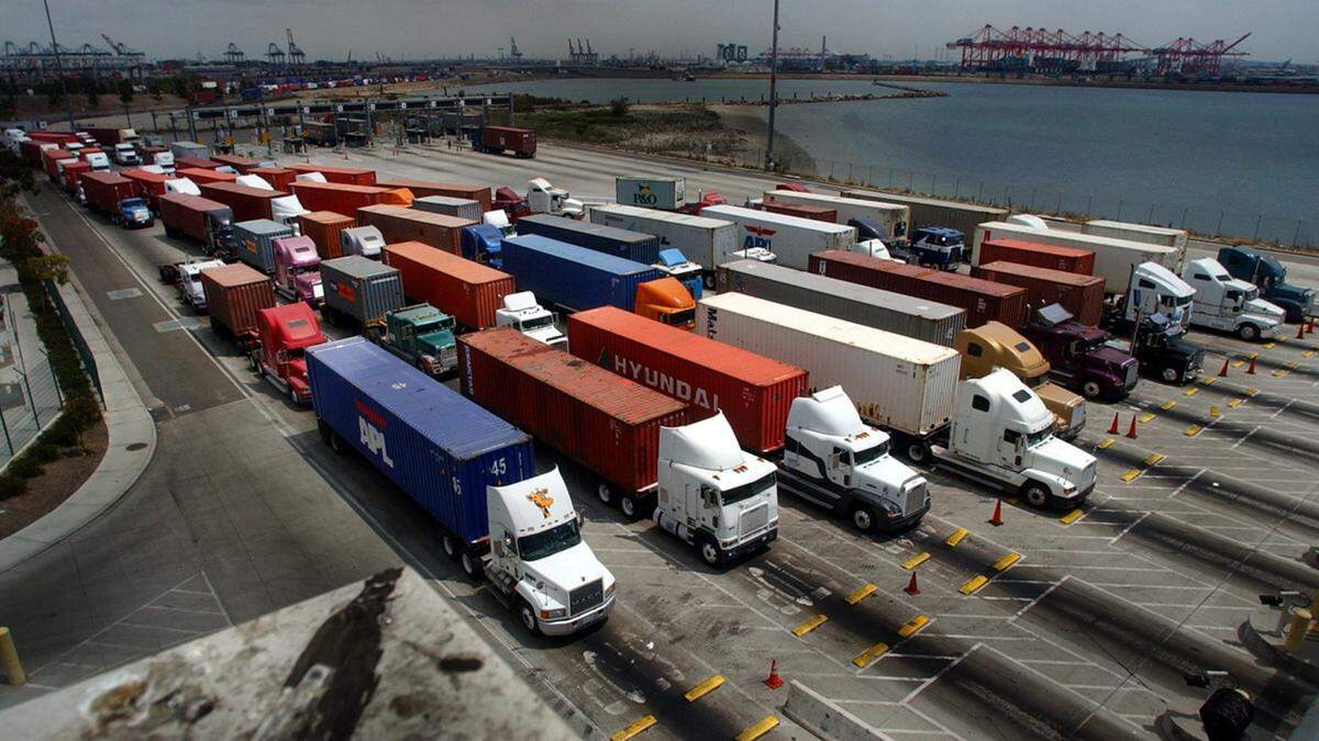 Truckers line up at the entrance of a cargo terminal in the Port of Long Beach. The California Trucking Association secured a court injunction blocking implementation of Assembly Bill 5 in its industry, arguing the law is preempted by the U.S. Constitution because the state is interfering with interstate commerce.