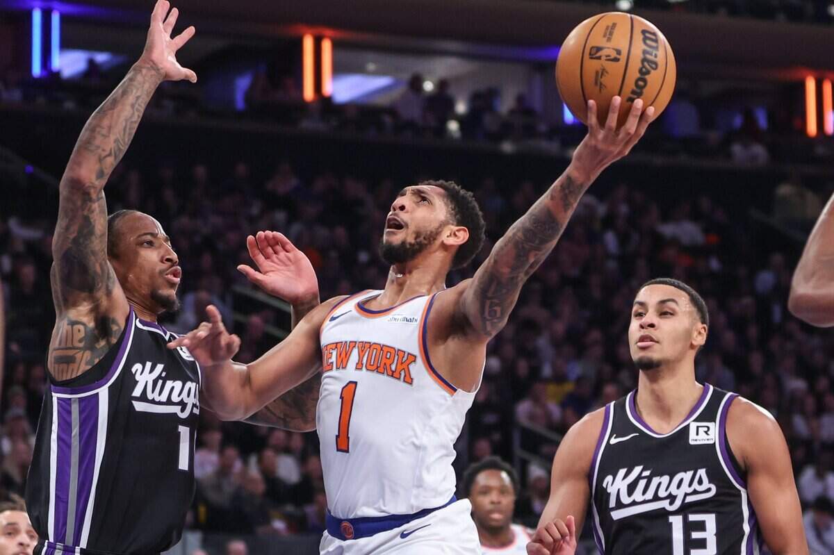 Jan 25, 2025; New York, New York, USA;  New York Knicks guard Cameron Payne (1) drives against Sacramento Kings forward DeMar DeRozan (10) in the second quarter at Madison Square Garden. Mandatory Credit: Wendell Cruz-Imagn Images