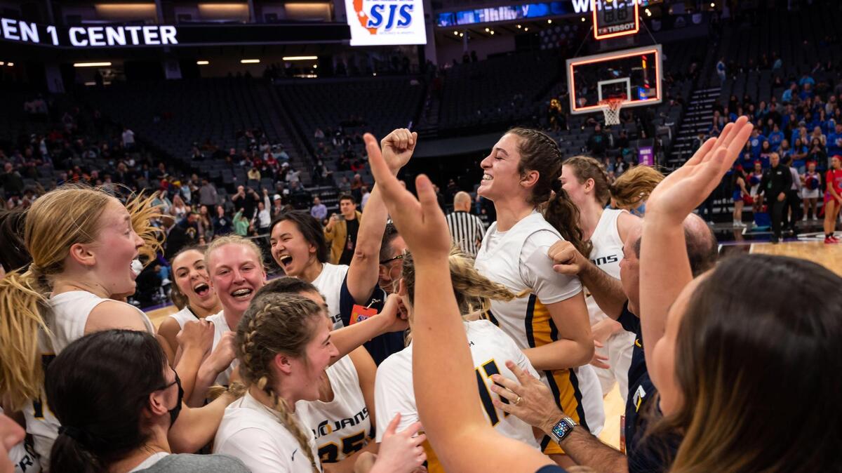 The Oak Ridge Trojans celebrate their 41-40 win over the Folsom Bulldogs for the high school girls basketball Sac-Joaquin Section Division I title Saturday, Feb. 26, 2022, at Golden 1 Center in Sacramento.