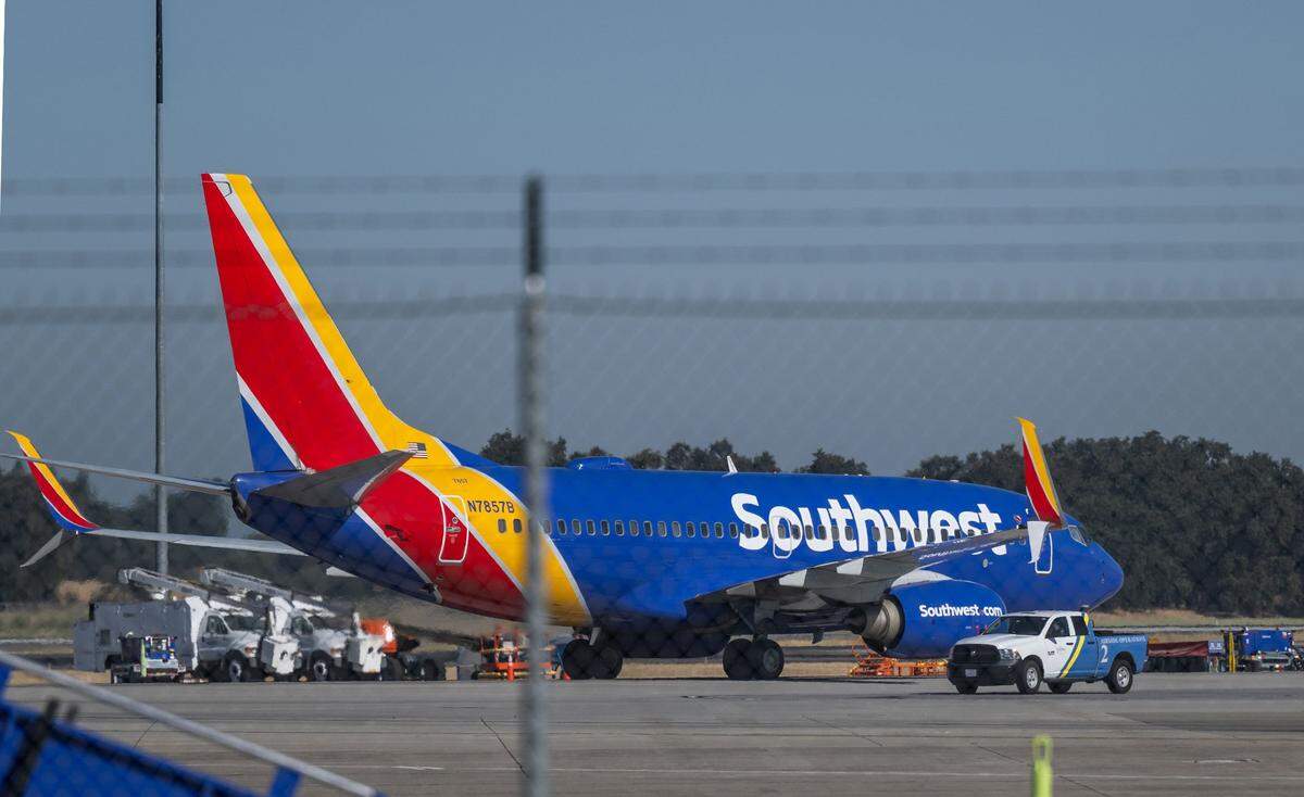 A Southwest Airlines plane taxis to the Sacramento International Airport Terminal B during a groundbreaking ceremony for the SMForward program on Monday, Aug. 5, 2024. The construction project includes a new parking garage and a pedestrian skyway between Terminal B and Concourse B.