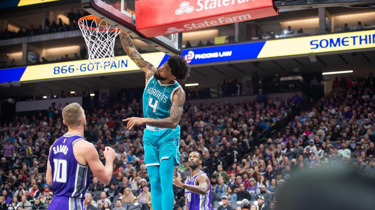 Charlotte Hornets center Nick Richards (4) has to tilt his had to not hit the backboard on the reverse dunk during the second half in the NBA basketball game Monday, Dec. 19, 2022, at Golden 1 Center in Sacramento. The Hornets won 125-119.