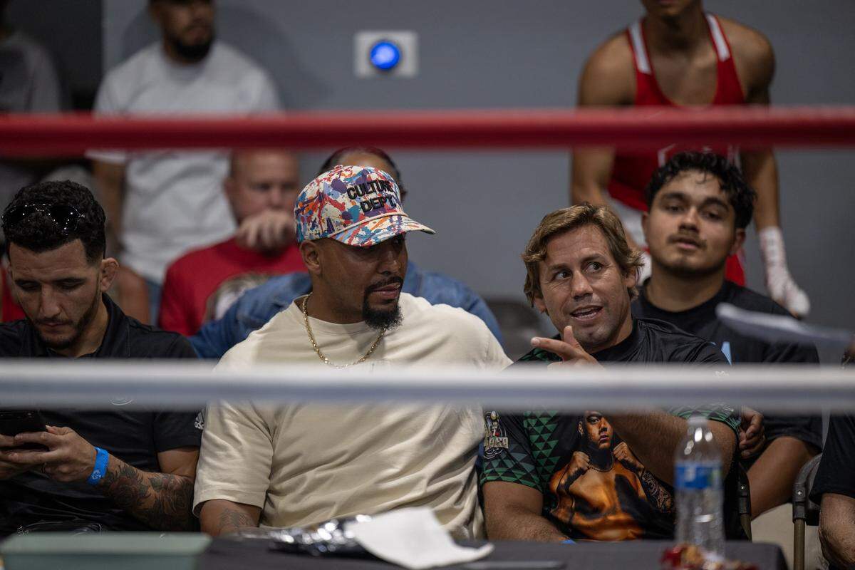 Two-time world boxing champion Andre Ward, left, and retired MMA star Urijah Faber, right, sit ringside at Flawless Fitness in Sacramento on Saturday.