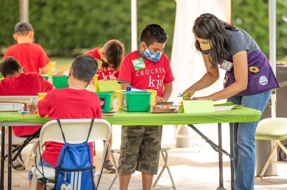 Alex Moctezuma works with instructor Crystal Ruiz at a weeklong art camp at the Crocker Art Museum.