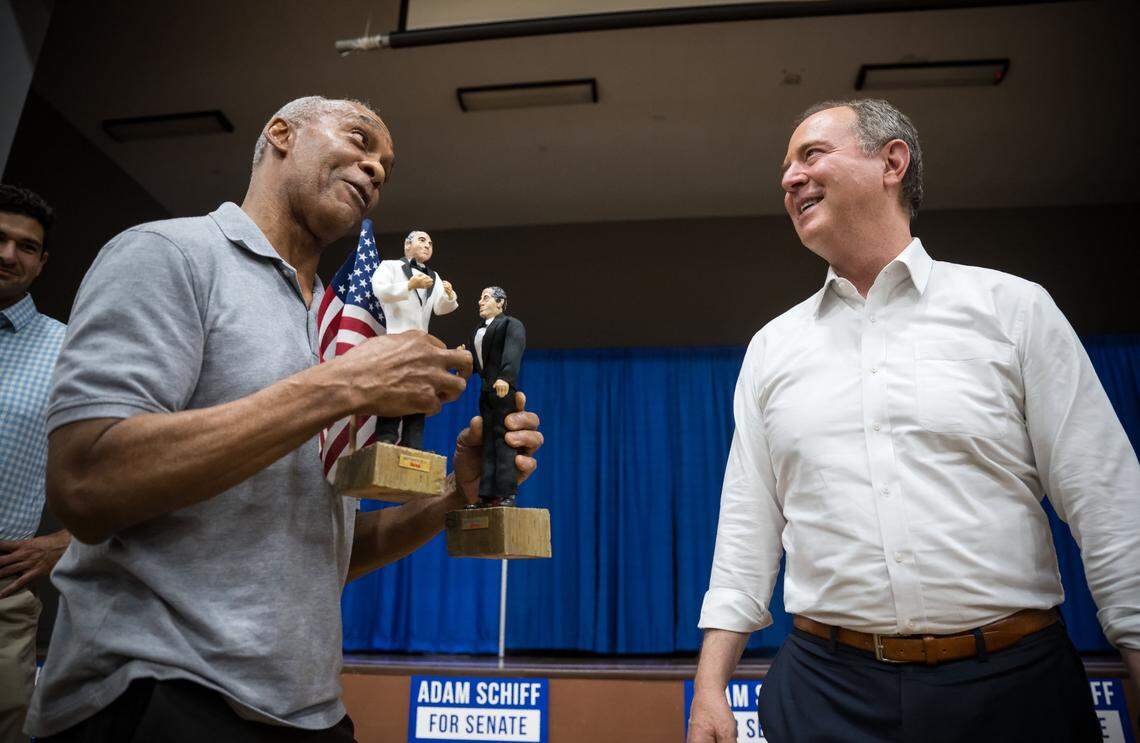 U.S. Rep. Adam Schiff, right, is presented with handmade figurines of himself and Maryland Democratic Rep. Jamie Raskin by Oak Park Army veteran Tony Carpenter after a town hall event hosted by the Women Democrats of Sacramento County on Aug. 4. “I made them during the impeachment (of former President Donald Trump),” Carpenter said.