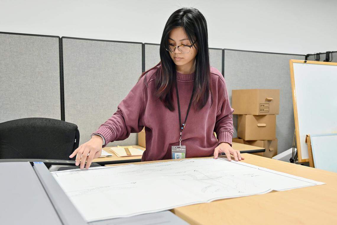 Student assistant Jessica Rilloraza scans a water rights map on a wide-format scanner at the State Water Resources Control Board offices in Sacramento in December.