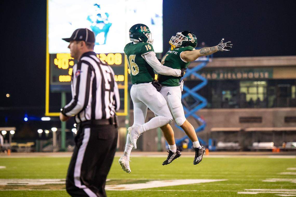 Sacramento State Hornets running back Cameron Skattebo, right, jumps up to celebrate with tight end Marshel Martin (16) after tossing him a touchdown pass on a double-pass play in the fourth quarter against University of the Incarnate Word at the FCS playoffs quarterfinal game Friday.