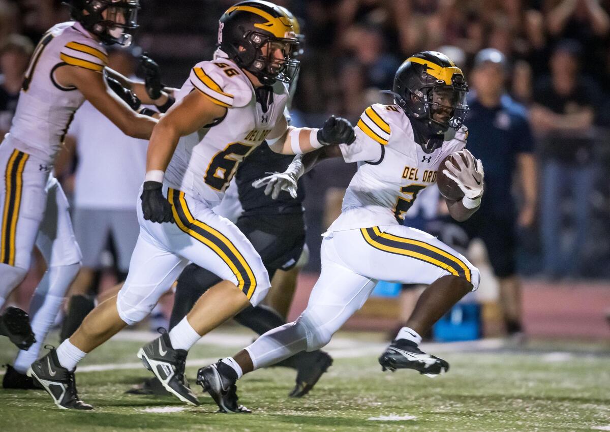 Del Oro Golden Eagles running back Marcel Urquhart (2), right, runs downfield into the end zone to score in the third quarter against the Casa Roble Rams at the high school football game Friday, Sept. 15, 2023, at Casa Roble High School in Orangevale.
