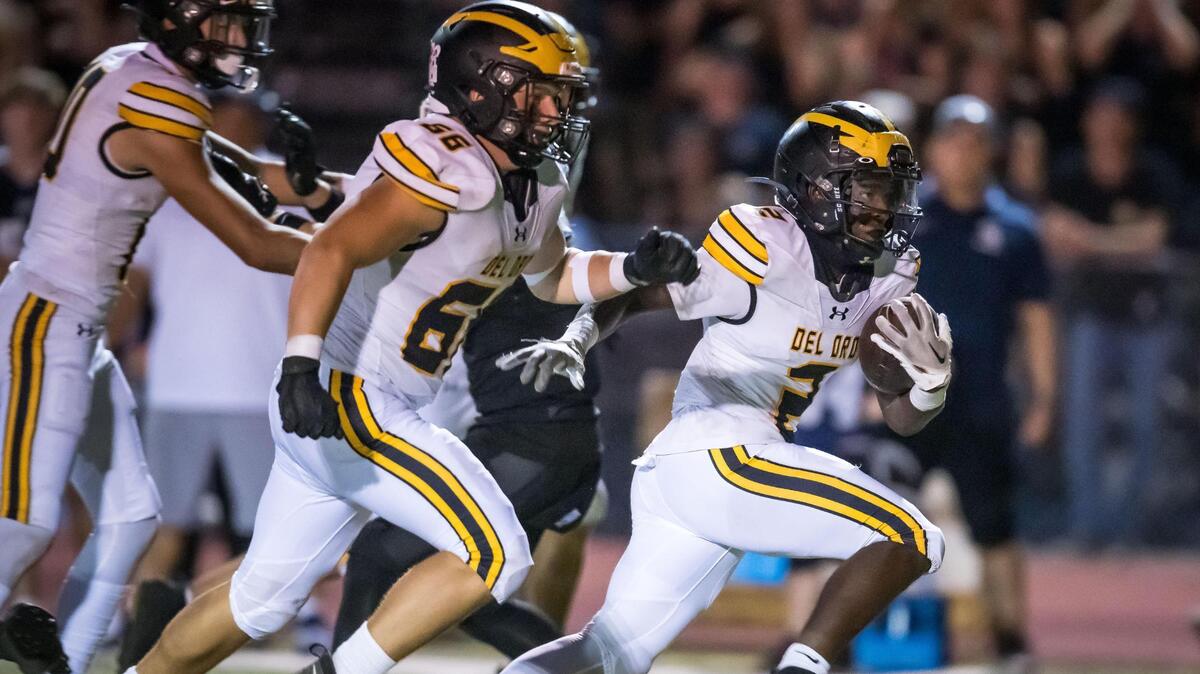 Del Oro Golden Eagles running back Marcel Urquhart (2), right, runs downfield into the end zone to score in the third quarter against the Casa Roble Rams on Friday in Orangevale.