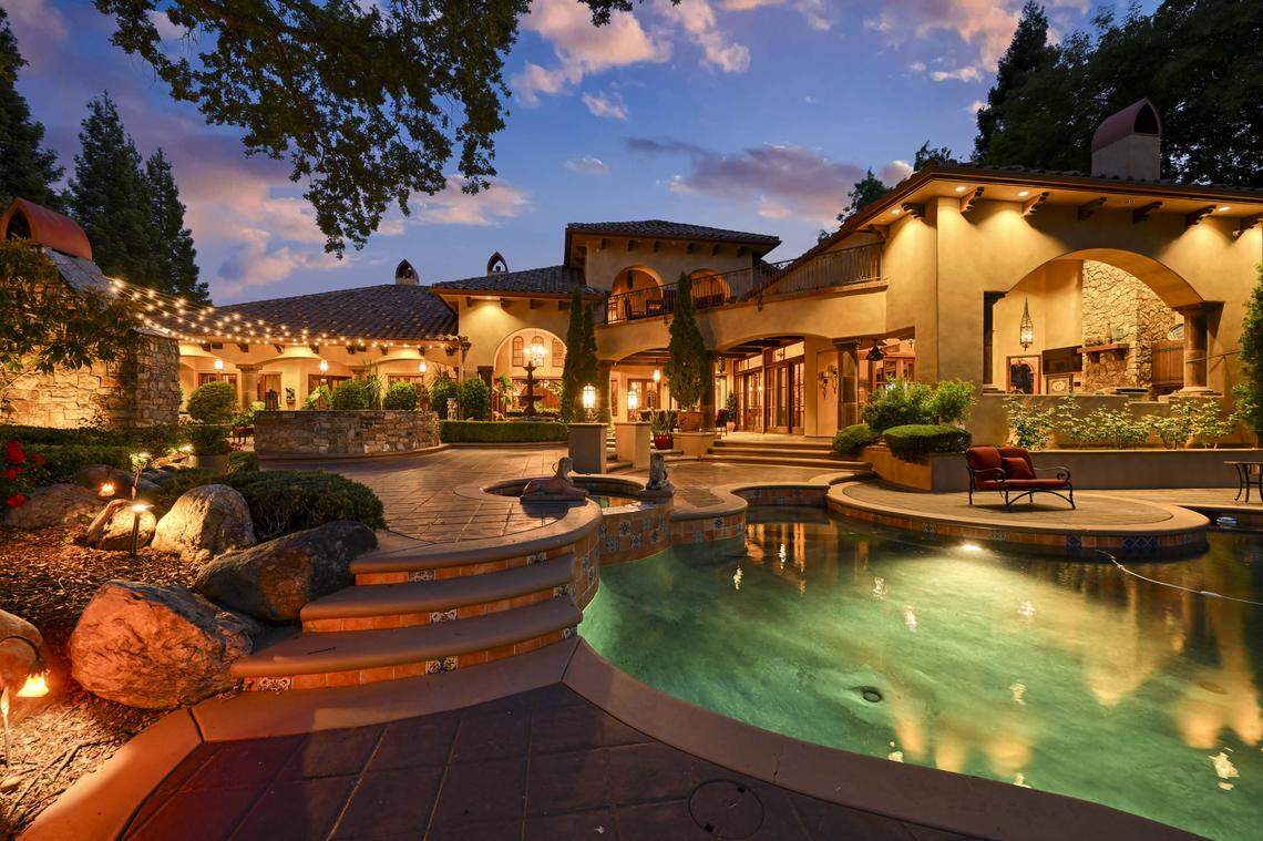 The home comes with resort-style living with the sparkling pool and spa, surrounded by lush, manicured grounds.