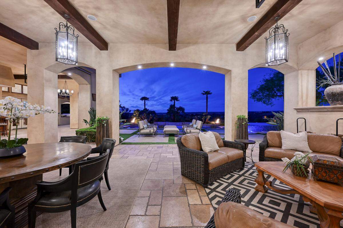 The mansion unfolds across 13,350 square feet of total living space and includes eight bedrooms, twelve bathrooms and Sierra foothill views.