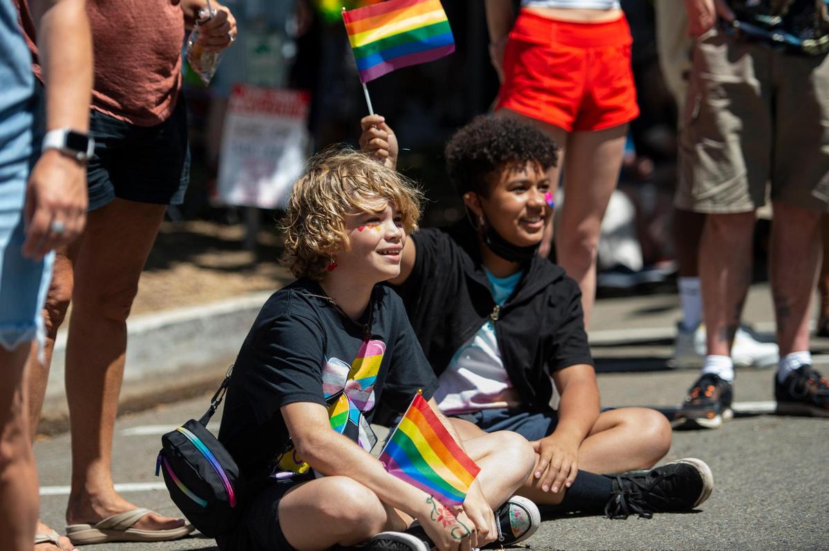 William Wimsatt, 12, and Athena Fiorentino, 12, watch was the Sacramento Pride March and Parade on Sunday, June 11, 2023, in downtown Sacramento. “I wanted to celebrate pride this year since both my parents are gay and I am gay,” said Fiorentino, attending the parade for the first time.