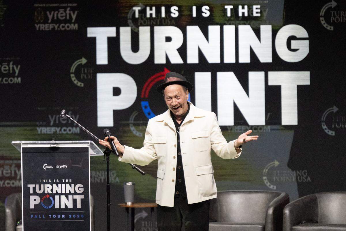 Comedian-actor Rob Schneider mimics actor Robert De Niro during a Turning Point USA tour event at UC Berkeley on Monday, Nov. 10, 2025. 