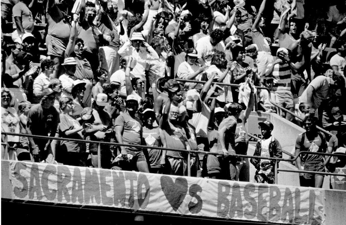 "Sacramento hearts baseball" reads a banner at the Oakland Coliseum as some of 21,000 Sacramento-area baseball fans participating in the "March on Baseball" watch the Athletics play the New York Yankees on Aug. 23, 1987.