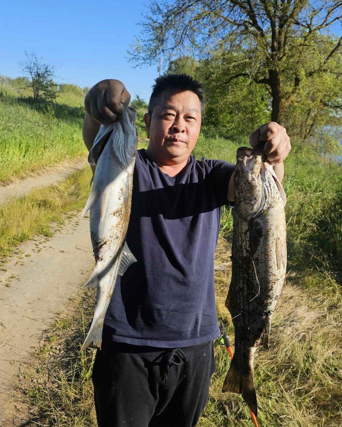 Bee Lao poses with a fresh catch. Lao, a 46-year-old father who worked for Sutter Health, was one of at least 22 cyclists and pedestrians to die in vehicle collisions on Sacramento streets in 2025.