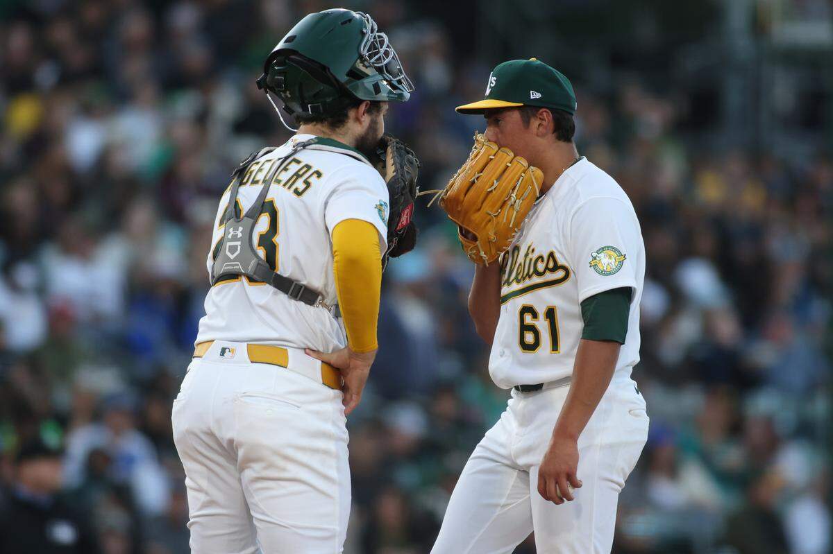 Pitcher Gage Jump of the Athletics and catcher Shea Langeliers of the Athletics talk during a mound visit during the fourth inning against the Seattle Mariners at Sutter Health Park on May 26. Jump’s second start Tuesday vs. the Chicago Cubs went better than his first, and he earned his first MLB win.