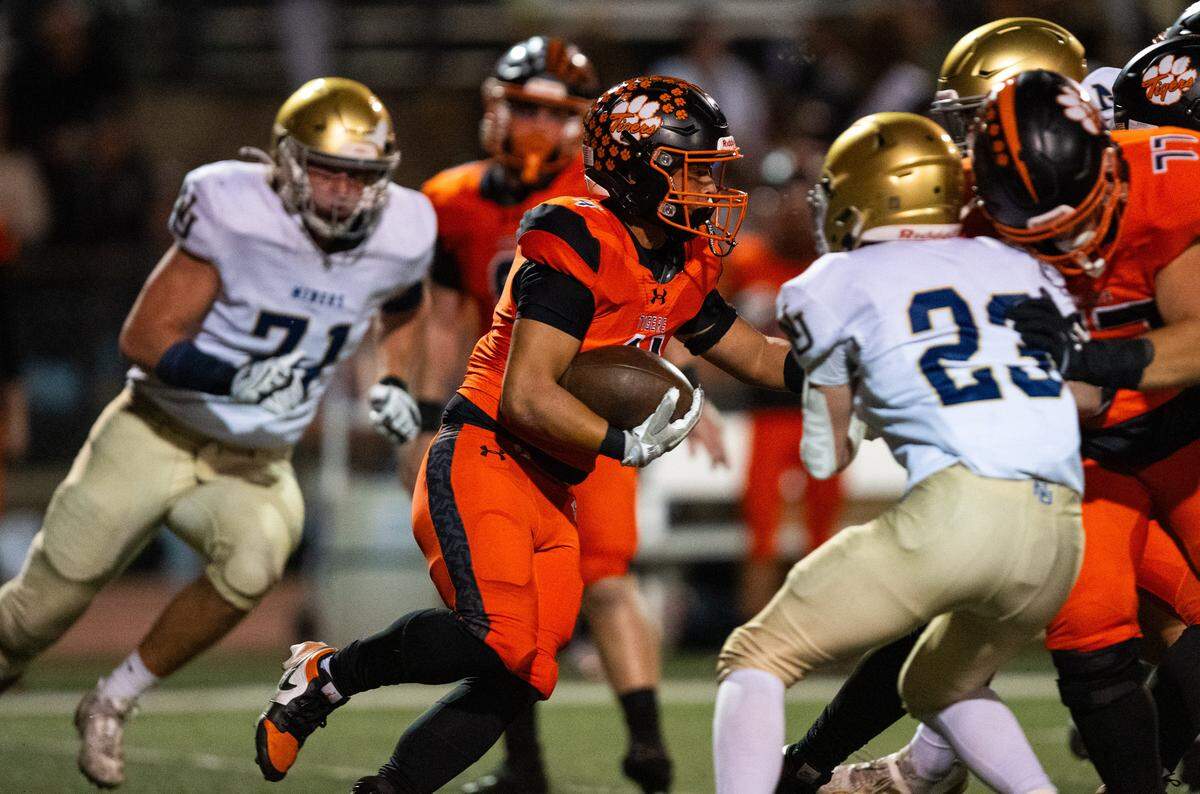 The Roseville Tigers’ Cole Takahashi (4) rushes for a 12-yard gain against the Nevada Union Miners on Friday in Roseville. The No. 12 Tigers face unbeaten No. 7 Twelve Bridges on Friday.