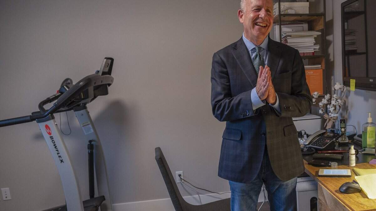 Sacramento Mayor Darrell Steinberg rubs sanitizer on his hands in his home office that doubles as an exercise room on Wednesday, April 22, 2020. He used the elliptical machine while the public tennis courts were closed because of the coronavirus concerns. He later said the office felt confining and depressing and moved to a room with more sunlight to work.