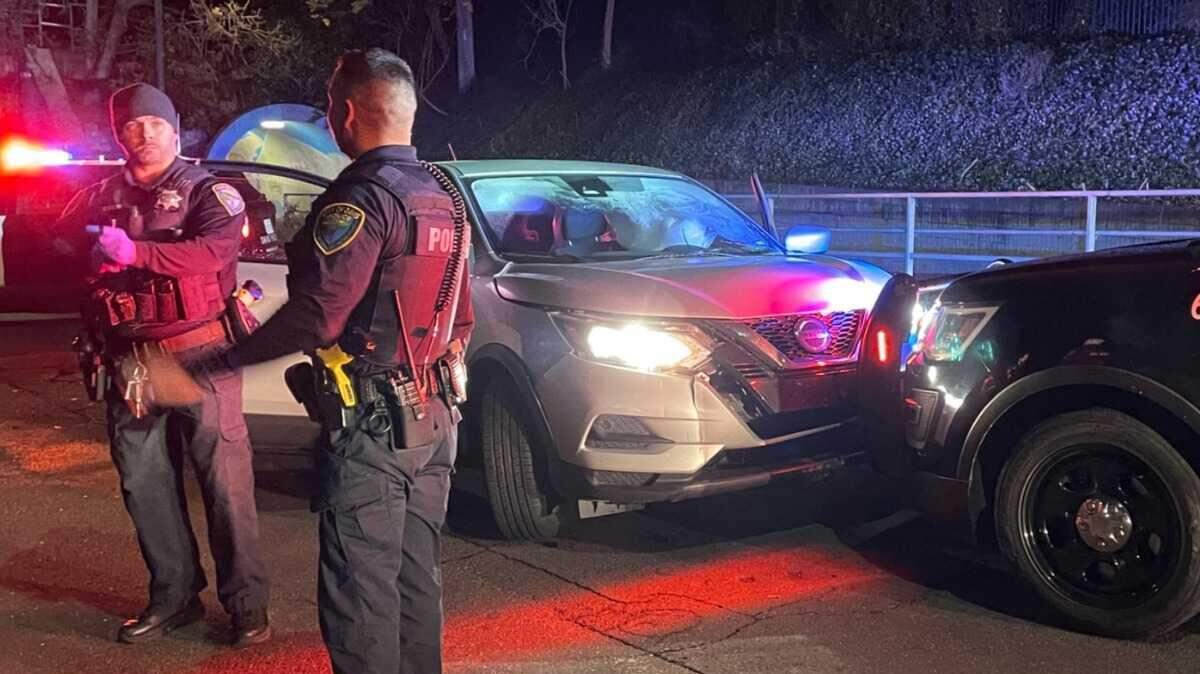 Davis police officers are seen Jan. 7, 2024, following incident in which a driver, suspected of being under the influence, drove through a fence before his vehicle went airborne on a busy downtown street. The driver was arrested, police said, and no one was injured.