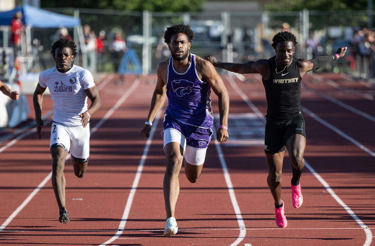 Ian Dossman of Franklin-EG, middle, wins the 100 meter race ahead of Xavier Bruce of Whitney, right, and Edison’s Ah’Marion Ashley, left, in the CIF Sac-Joaquin Section Masters track finals at Davis High School in Davis, Calif., Saturday, May 20, 2023.