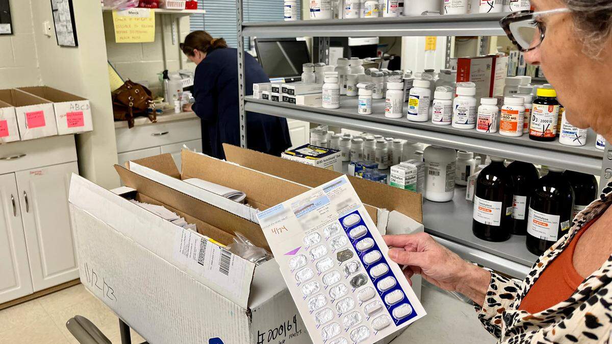 Pharmacist Frieda Martin holds a donated medication blister pack Nov. 7 at Open Bible Clinic and Pharmacy in Colorado Springs, Colo. California and Colorado are among the states looking to expand their drug donation programs, putting them in the hands of low-income patients.