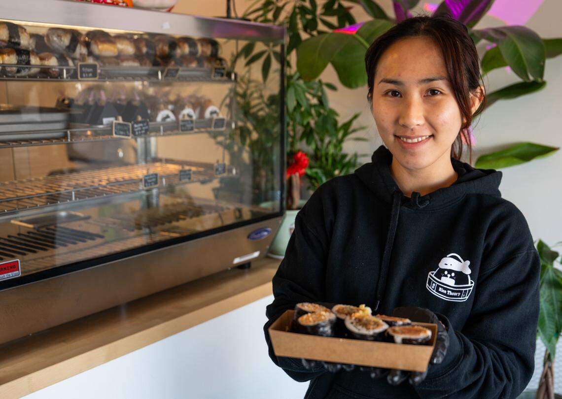 Server Ingmey Ny holds a selection of rolls – including kurobuta sausage, sukiyaki beef and shrimp tempura&nbsp;– at Rice Theory on Freeport Boulevard in Sacramento last week.