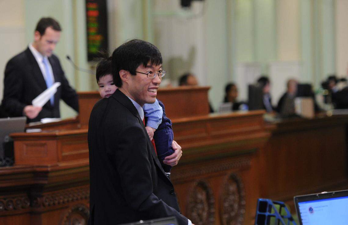 Richard Pan, newly elected by Sacramento region voters, carries his five-month-old son Alexander as the California Assembly meets for its first organizational session to swear in legislators in 2010.