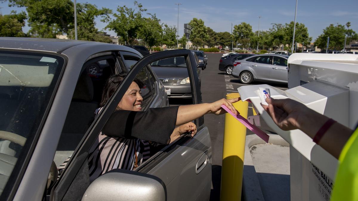 Yesenia Siguenza of Sacramento drops her ballot into the ballot box outside of the Voter Registration and Elections office on 65th Street in South Sacramento on Tuesday, June 5, 2018.