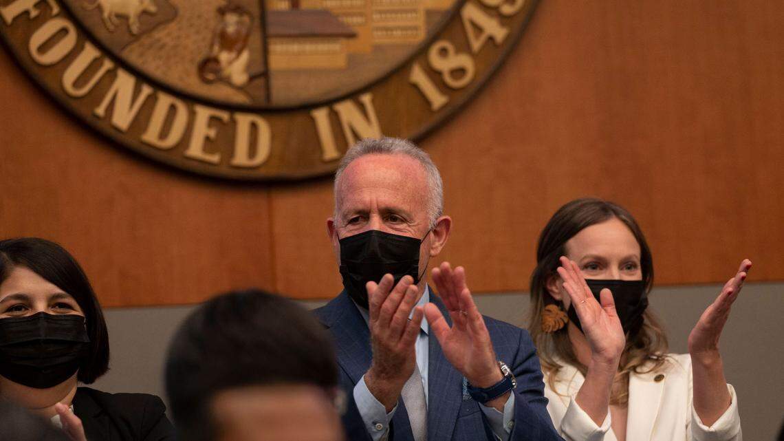 Caity Maple sits on the dais next to Mayor Darrell Steinberg on her first day as a Sacramento City Council member Tuesday, Dec. 13, 2022.