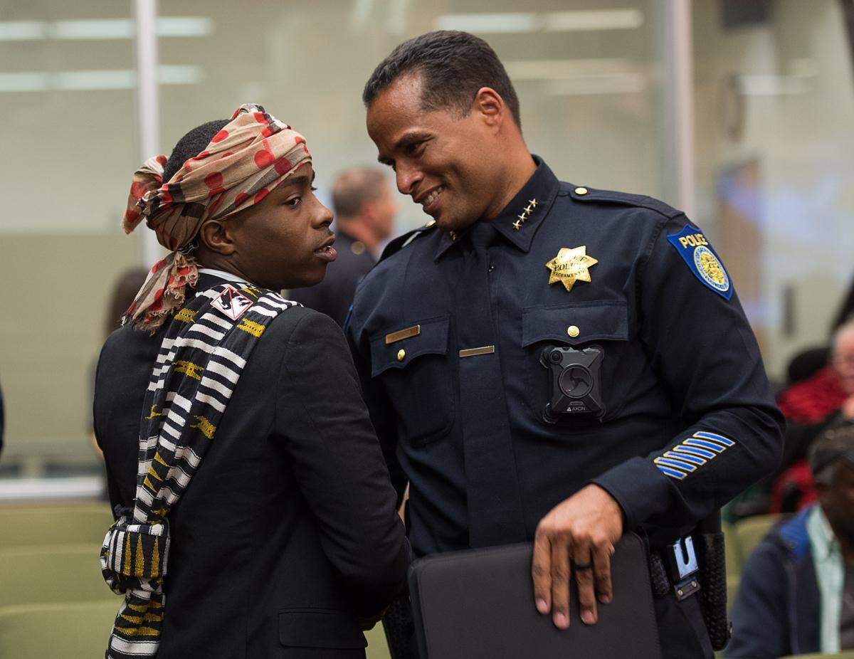 Stevante Clark talks with Chief Daniel Hahn before a Sacramento City Council meeting in 2018, about a month after Clark’s brother, Stephon, was fatally shot by police.