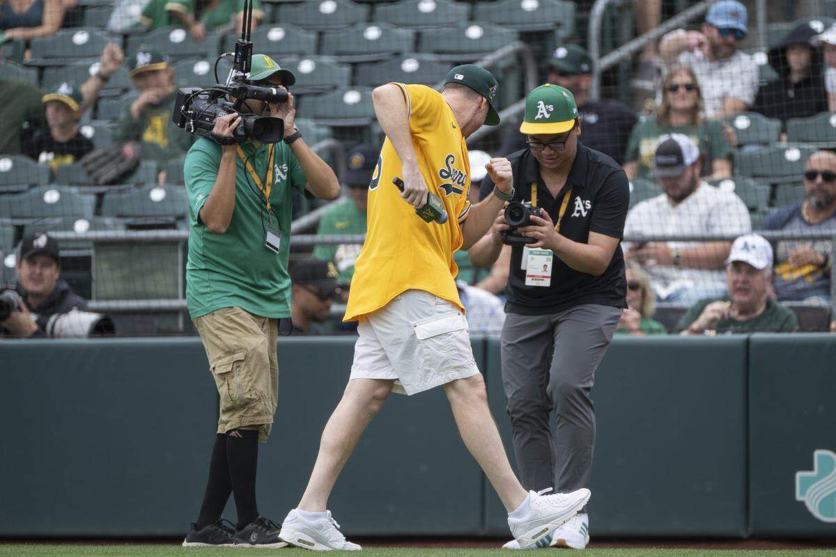 Stadium host Eric Fielden shows off the new Athletics jersey for the 2026 season with “Sacramento” emblazoned across its front during as the team played the Kansas City Royals at Sutter Health Park in West Sacramento for the final game of the season on Sunday.