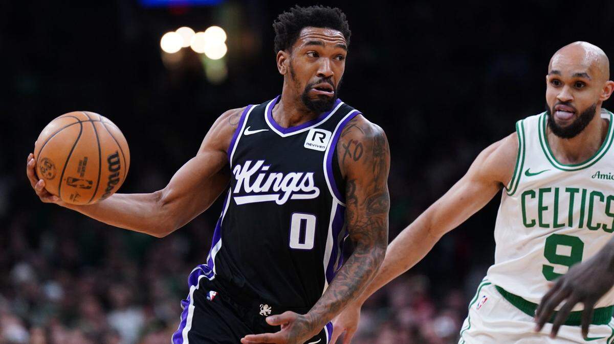 Jan 10, 2025; Boston, Massachusetts, USA; Sacramento Kings guard Malik Monk (0) passes the ball against Boston Celtics guard Derrick White (9) in the first quarter at TD Garden. Mandatory Credit: David Butler II-Imagn Images