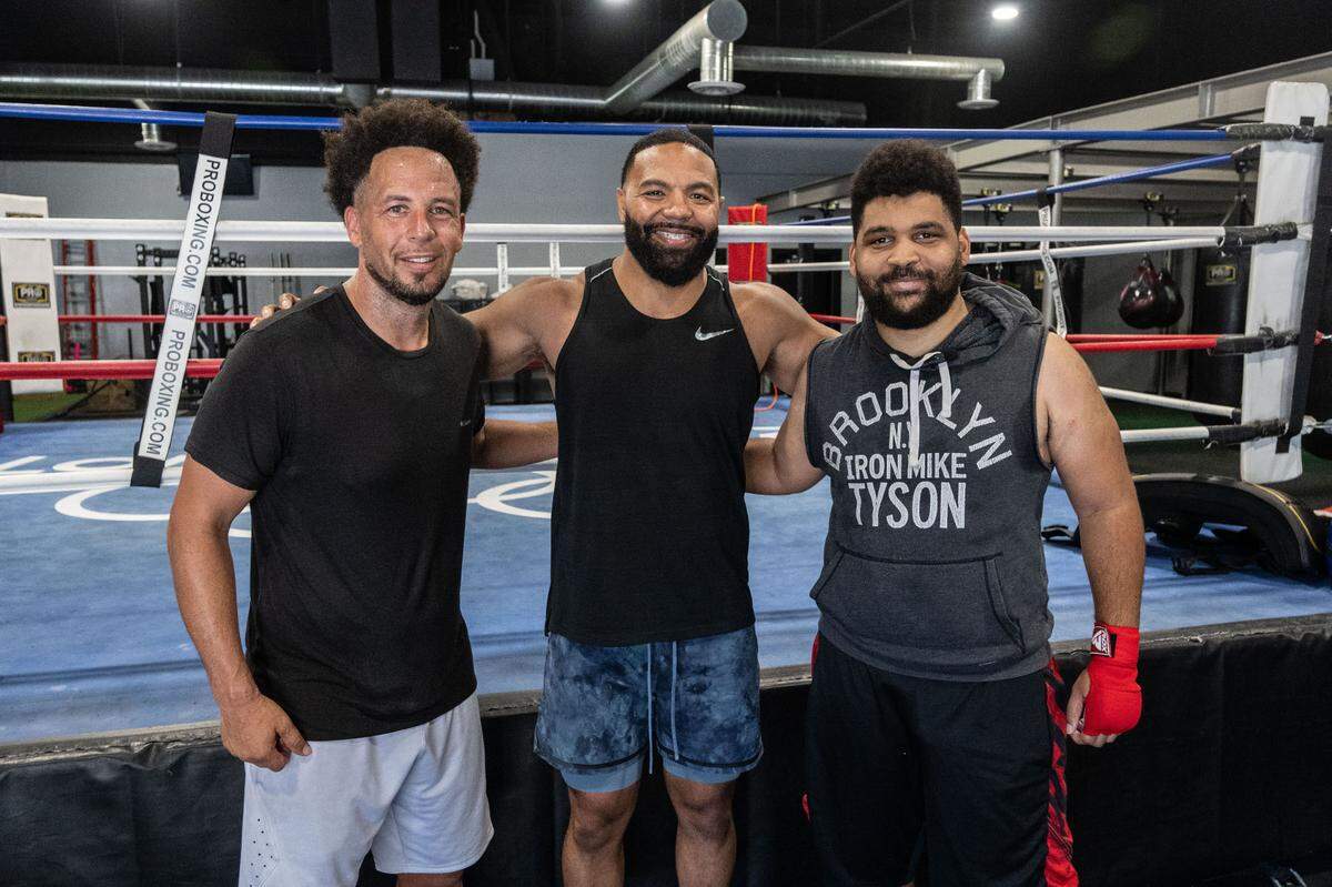 Sacramento State president Luke Wood, left, poses for a photo with Combat U boxing coach Brandon Gonzalez, center, and Sacramento Bee opinion columnist LeBron Hill at Flawless Boxing & Fitness last month.