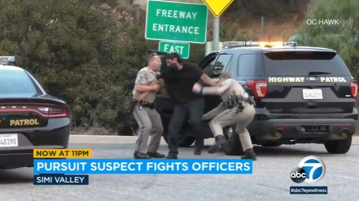Videos show a man fighting California Highway Patrol officers Sunday after crashing into a guardrail during a chase on Highway 118 in Simi Valley, police say.
