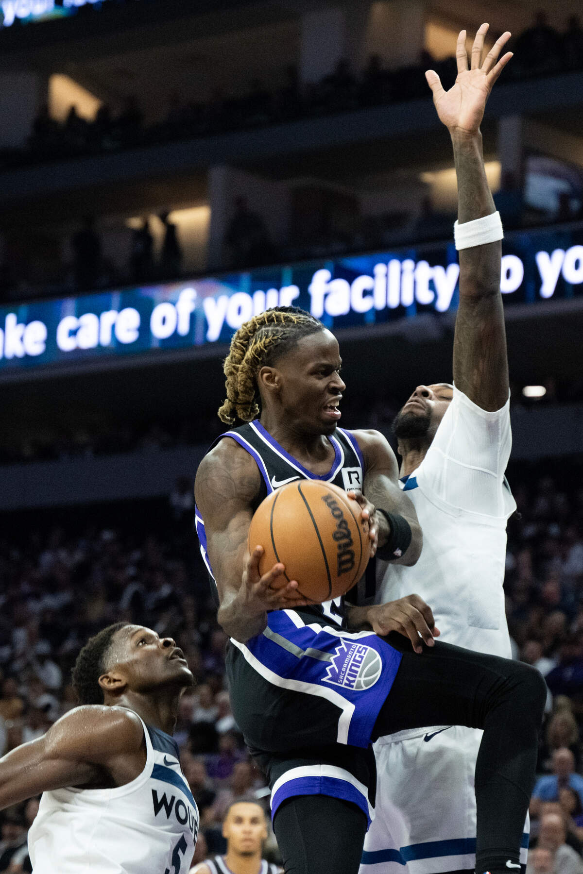 Sacramento Kings guard Keon Ellis (23) is fouled by Minnesota Timberwolves center Naz Reid (11) during the season opener at Golden 1 Center on Thursday, Oct. 24, 2024 in Sacramento.