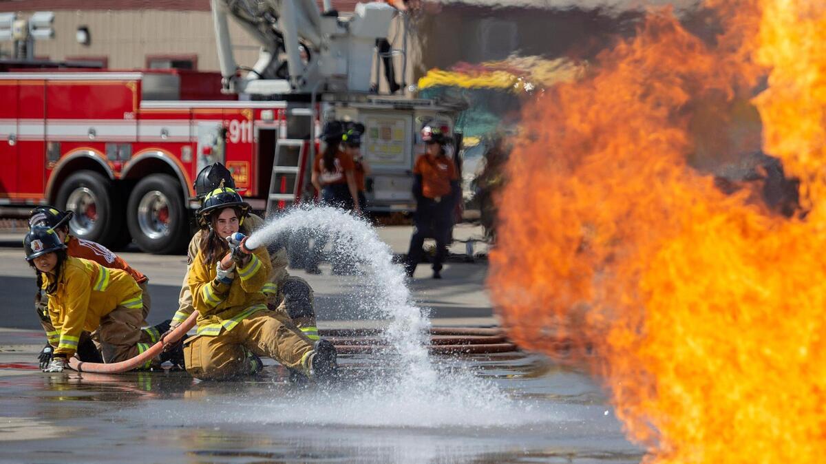 Nina Santini, 15, puts out a mock fire during the HERo Girls Fire Camp, hosted by the Cosumnes Fire Department, on Sunday at the William Perry Schulze Fire Training Facility in Elk Grove. The two-day all-girls fire camp had 18 agencies volunteer to assist the 43 high school-aged girls through stations that simulated tasks firefighters perform.