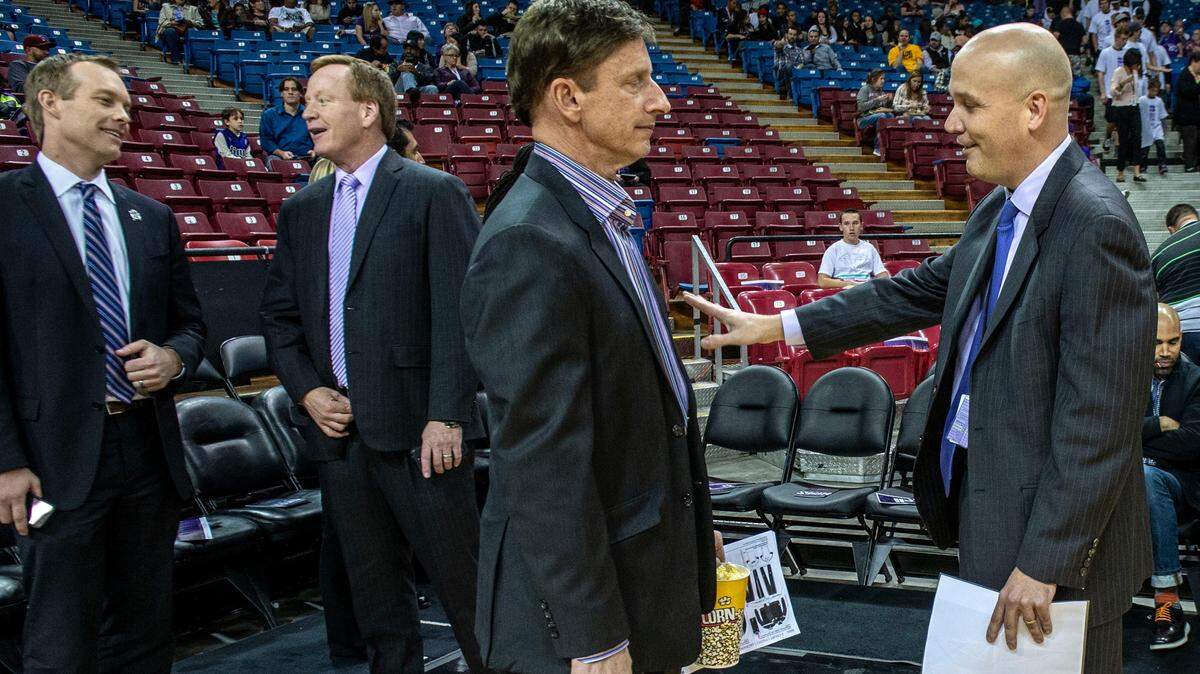 Then-Kings executive Jeff David, far left, talks to radio host Grant Napear before the Kings play the Indiana Pacers on Friday, Jan. 24, 2014, at Sleep Train Arena. At right, then-team President Chris Granger talks to minority owner Mark Mastrov, center. David pleaded guilty Tuesday in federal court in Sacramento to diverting $13.4 million from team sponsors.