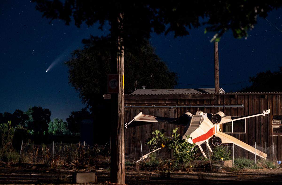 Comet Neowise streaks across the northwestern sky shortly after sunset Tuesday, July 14, 2020, seen past a wooden replica X-wing fighter from “Star Wars” in Jayson and Jennifer Lamoree’s garden at home on County Road 20 in Woodland. The homemade spacecraft, built by volunteers from Calvary Baptist Church in Woodland, helped secure a win as part of a float in the 2019 Woodland Holiday Parade.