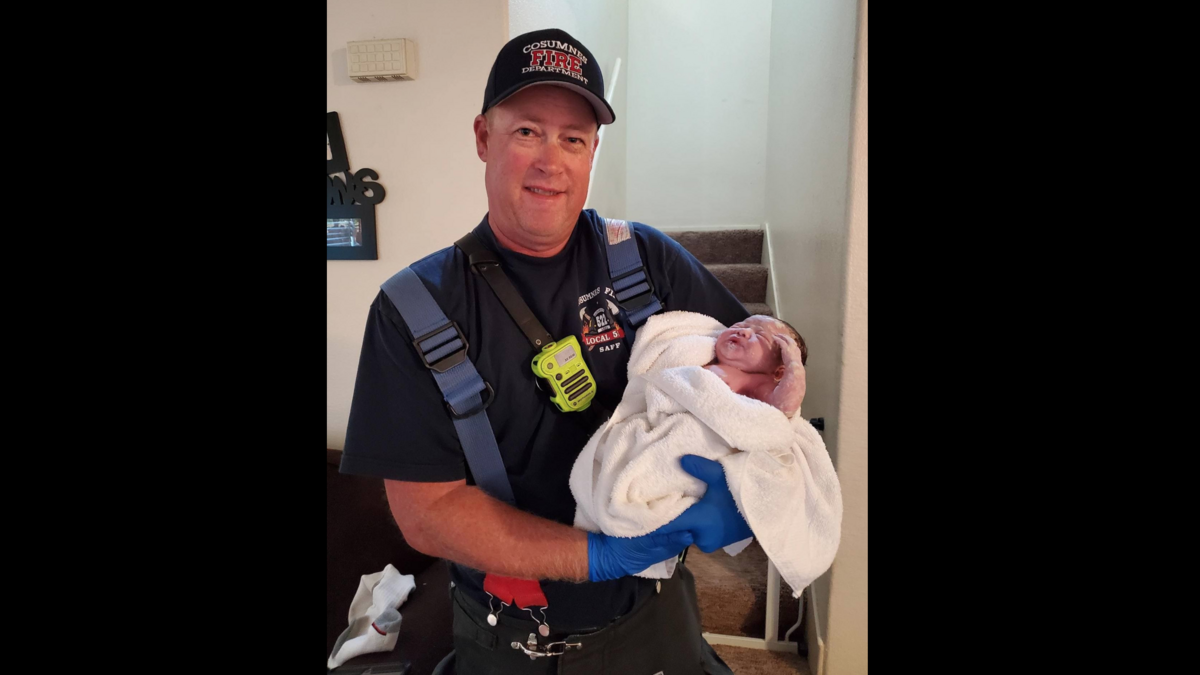 Cosumnes Fire Department captain Don McCoy holding the baby he helped deliver