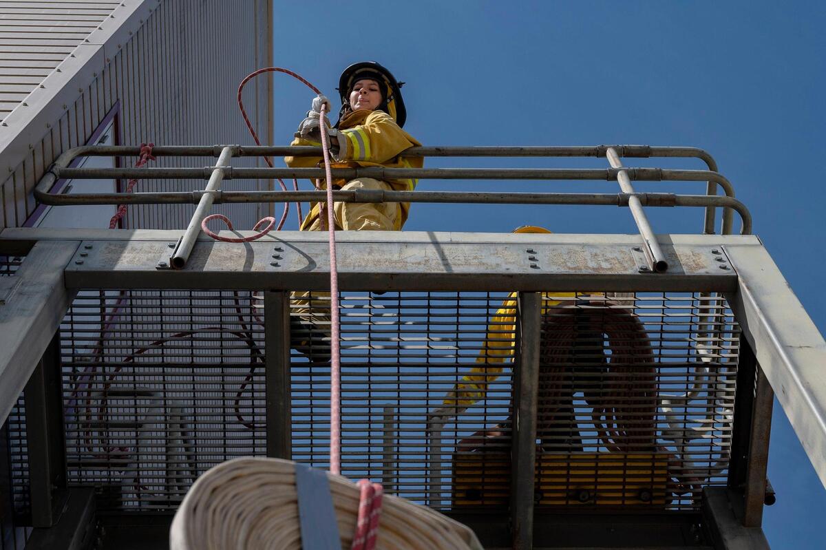 Kailynn Munoz, 17, pulls a roughly 10 pound hose up a flight of stairs during the physical ability test station on Sunday. “I know how to use a chainsaw now, so that’s cool,” said Munoz about what she learned at the camp.